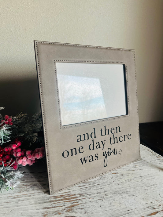 Beige picture frame with text on a wooden surface